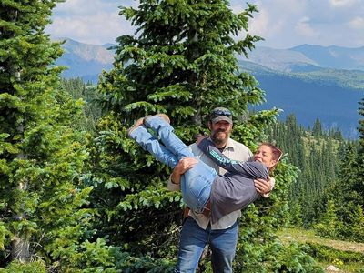 Kirk Taylor with family outdoors in Colorado